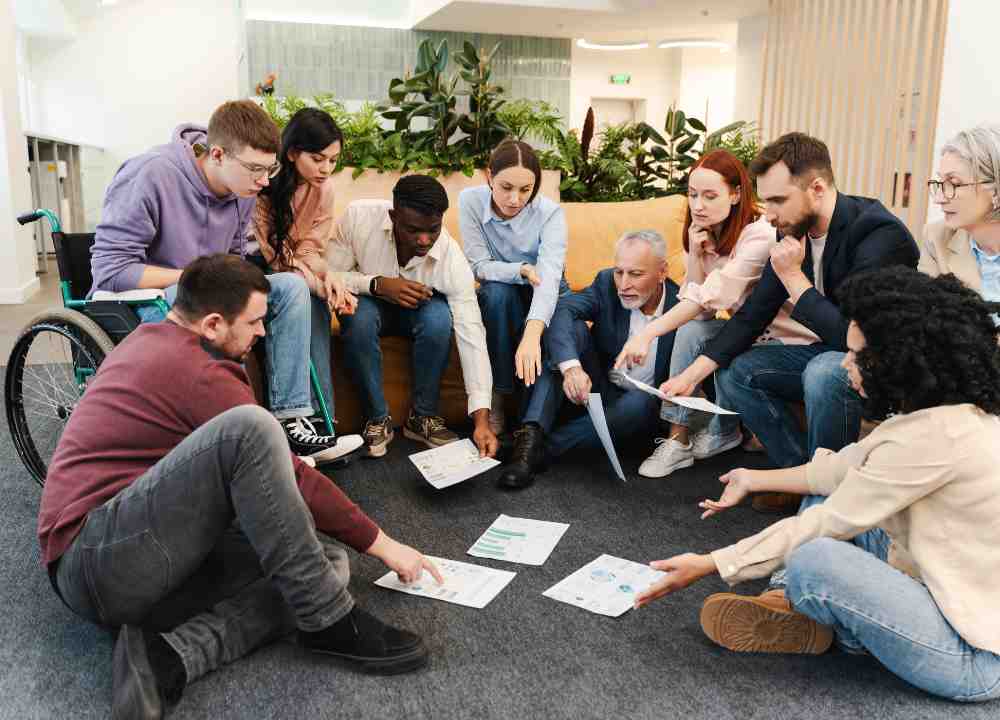 Agile team members in a Scrum meeting discussing project adjustments and changes, showcasing teamwork and flexibility in project management.